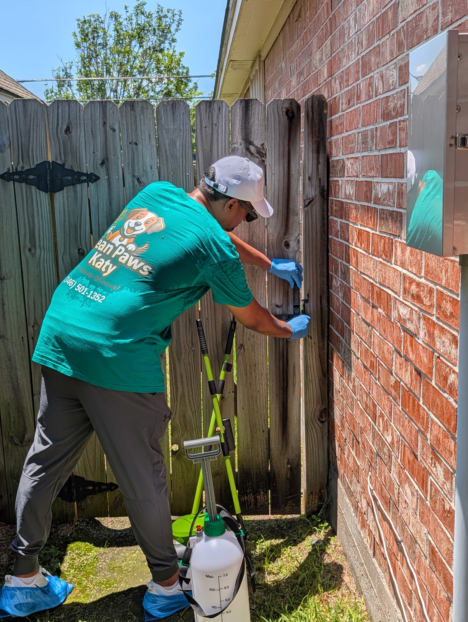 Sam securing the gate lock after a Clean Paws Katy service visit